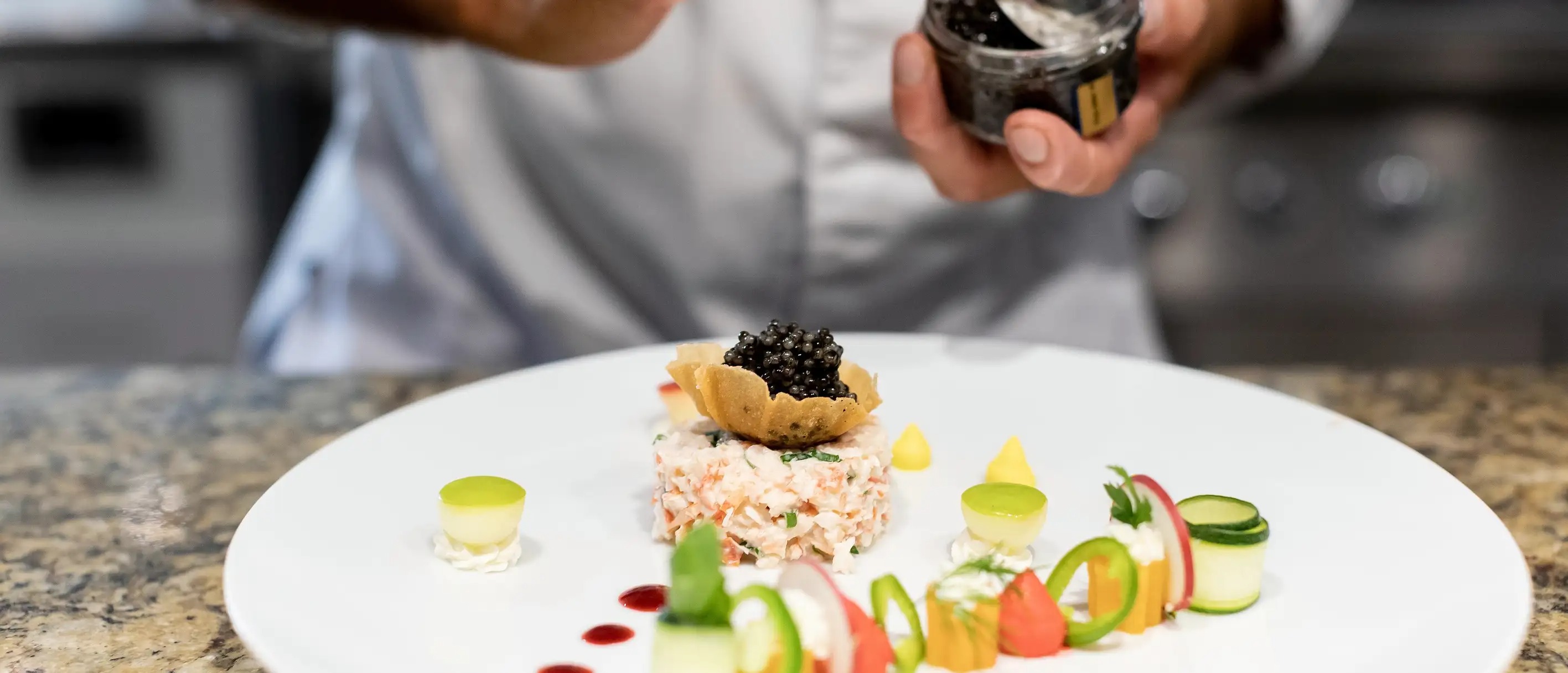 Chef finishing an elegant plated dish