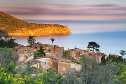 Sunlit coastal village and quiet bay in Mallorca