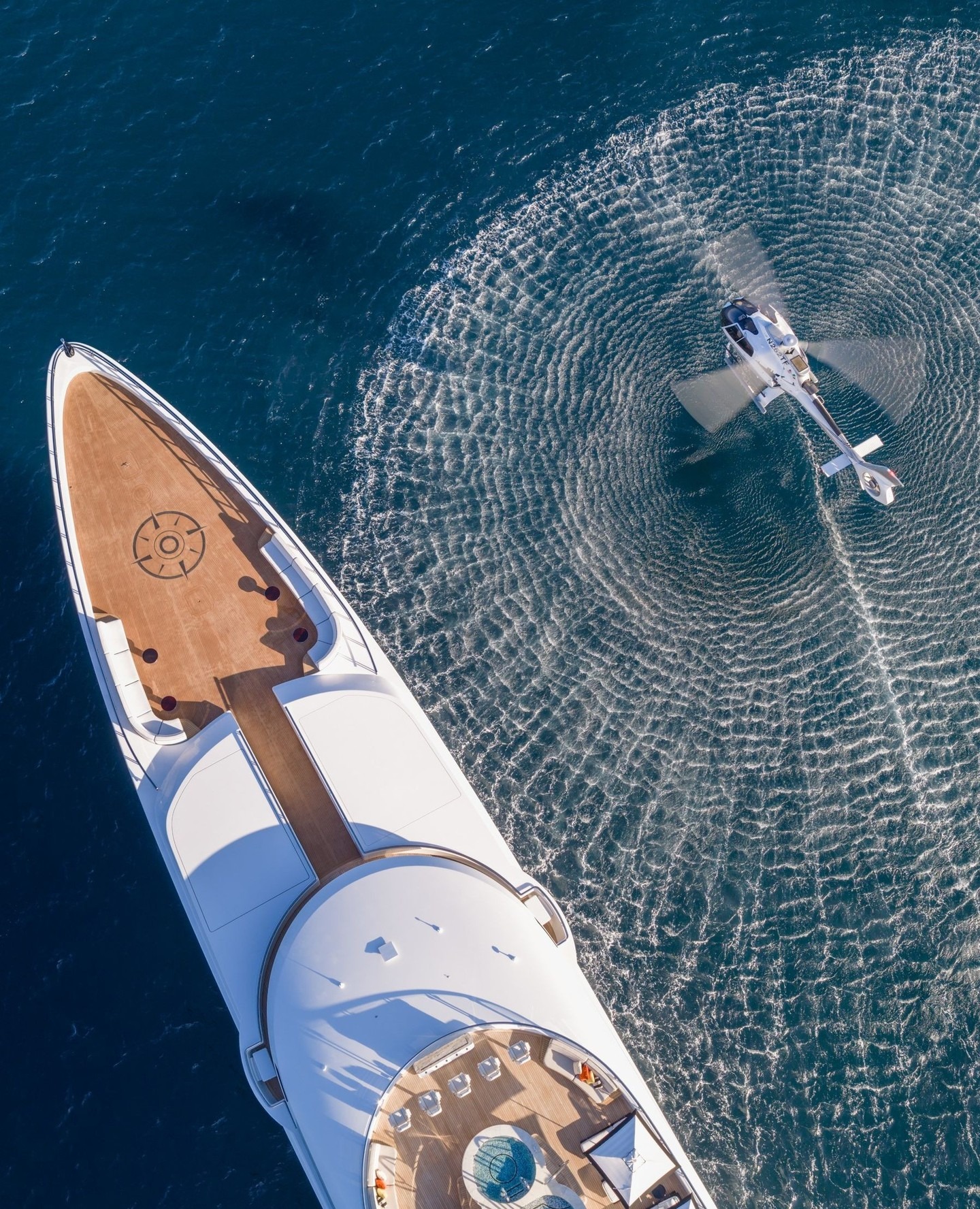 Aerial view of a yacht on deep blue water